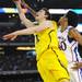 Michigan freshman Nik Stauskas shoots around Kansas senior Kevin Young during the first half at Cowboys Stadium in Arlington, Texas on March 29, 2013. Melanie Maxwell I AnnArbor.com
